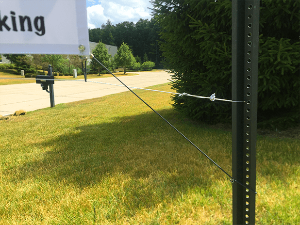 bungee cord attached from banner to pole